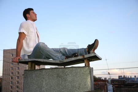 Man sits on the roof