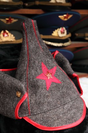 Budenny hat Red Army uniform with red star and police hats on ba