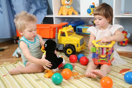 Two children in playroom with toys