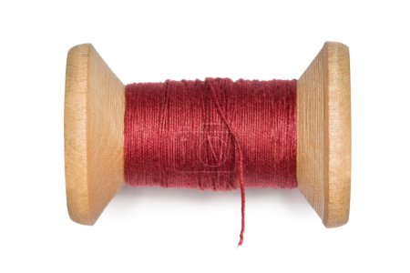 Wooden coil with red threads isolated on white background