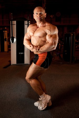 Bodybuilder demonstrates his muscles