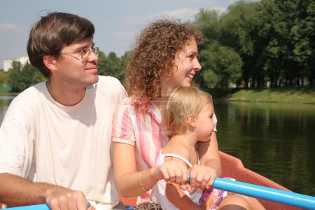 Family at the lake in the boat