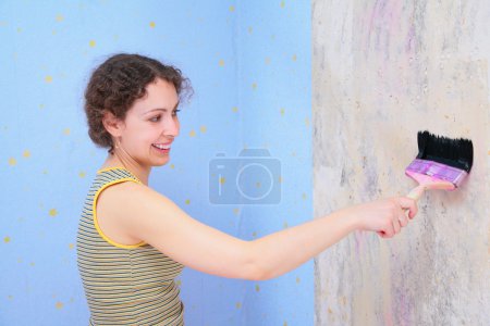 Young woman repairs room