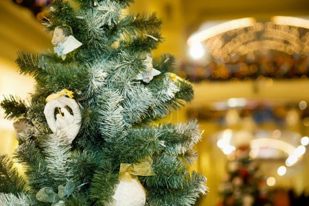 Christmas ornament in form of pigeons on fur-tree in shopping ce