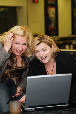Happy mature woman work on laptop
