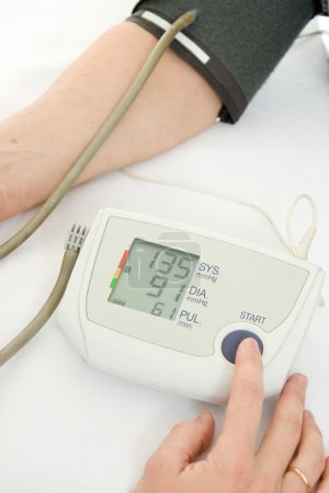 Hand an elderly woman with a sphygmomanometer on a white background.