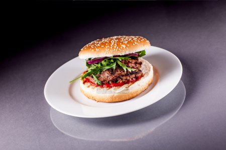 Hamburger with Arugula on Grey Surface