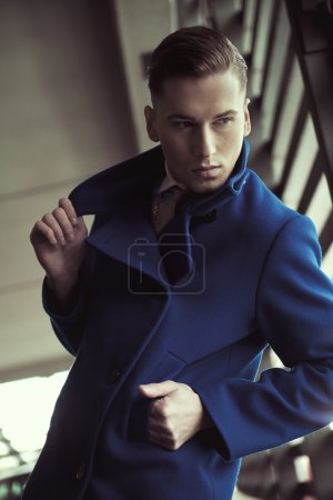 Young man in fashionable coat