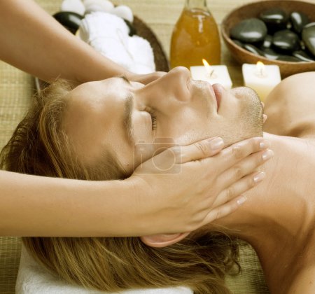 Spa. Young Man getting Face Massage