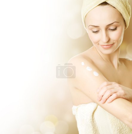 Beautiful Young Woman Applying Moisturizer. Skincare Concept