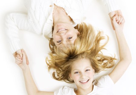 Happy Mother With Teenager Daughter Over White