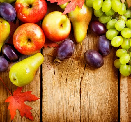 Organic Fruits over wood background. Autumn harvest