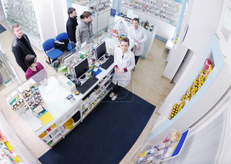 Pharmacist suggesting medical drug to buyer in pharmacy drugstore