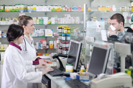 Pharmacist suggesting medical drug to buyer in pharmacy drugstore