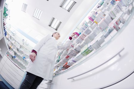 Pharmacist chemist woman standing in pharmacy drugstore