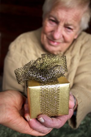 Senior holding a gift box