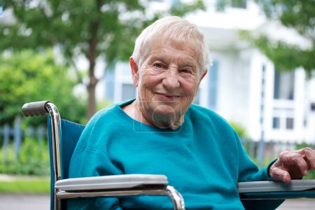 Happy senior lady in wheelchair