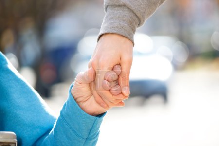 Caregiver Holding Senior's Hand