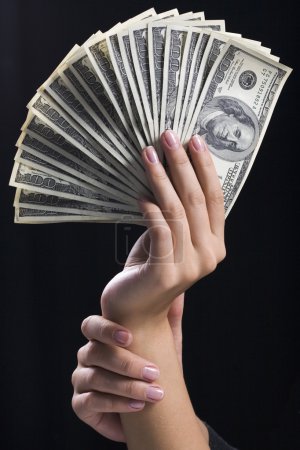 Hand holding money dollars