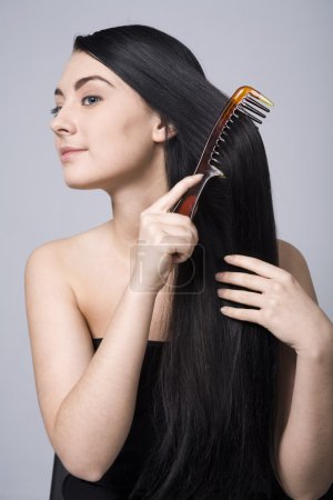 Woman doing her beautiful dark hair