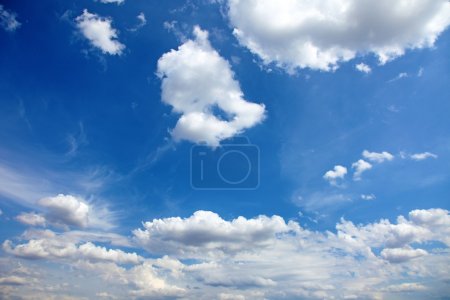 Beautiful blue summer sky with clouds as background or backdrop.