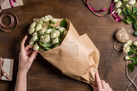 hands holding roses bouquet
