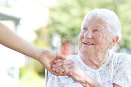 Senior Woman Holding Hands with Caretaker