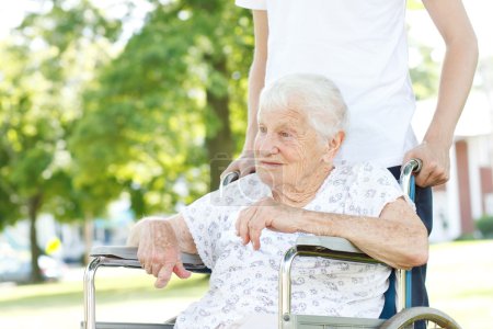Senior Women in Wheelchair with Caretaker
