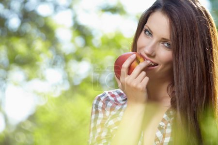 Beautiful woman in the garden with apples