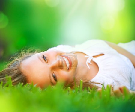 Spring Girl lying on the Field. Happiness